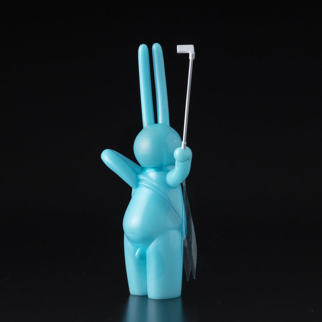 The Daily Flasher by mr. clement from Tomenosuke Shoten is a blue, glow-in-the-dark vinyl rabbit figurine standing upright with a white selfie stick in one hand, displayed against a black background.