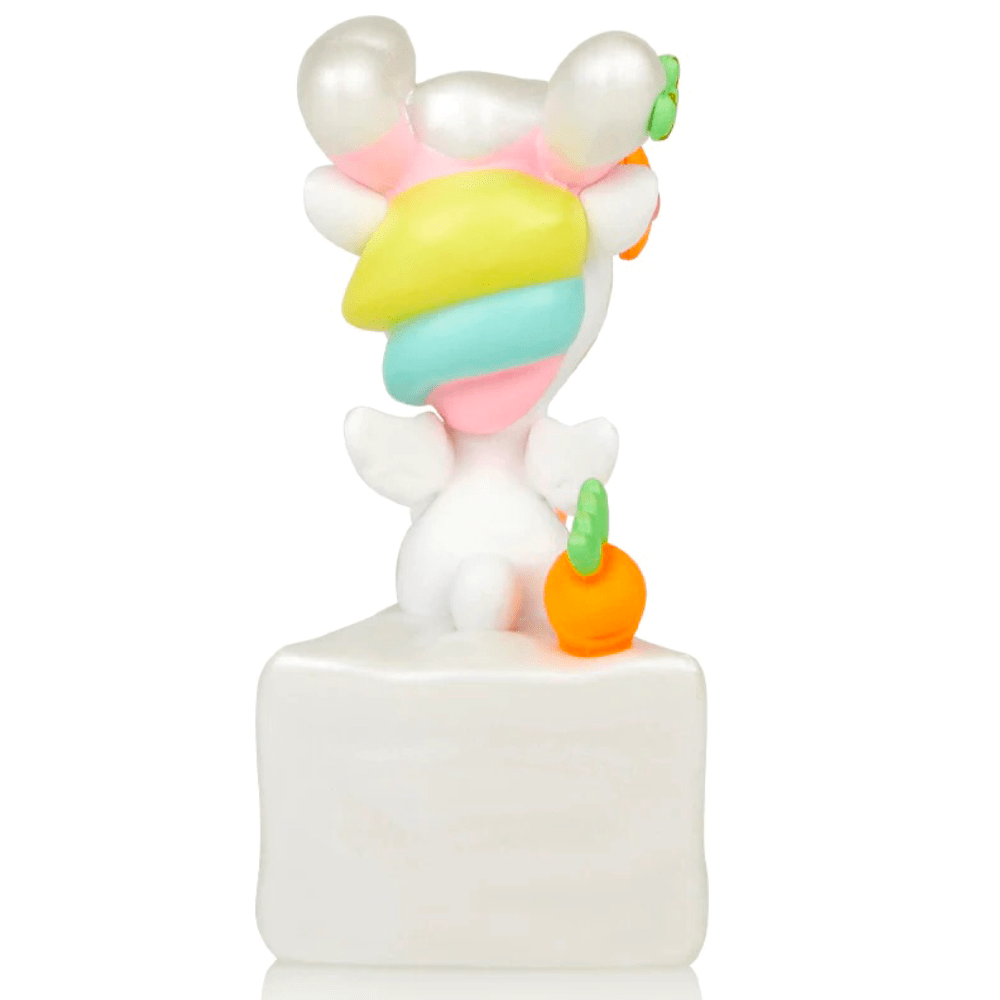A cute 14 Karrots Unicorno figurine by tokidoki on a white surface.
