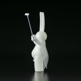 The Daily Flasher by mr. clement from Tomenosuke Shoten is a white rabbit sofubi figurine holding a selfie stick and wearing a sheer cape, posed against a plain black background.