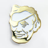 The Rotofugi Pirate Abe Enamel Pin by Rotofugi features a gold and white pirate face with stylized details—ideal as a mascot pin for designer toy shops or any enamel pin collection.