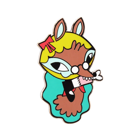 The Artpin Collection - The Wolf by Horrible Adorables: a cartoon-style enamel pin featuring a wolf in glasses with a yellow wig, red bow, teal cloak, and paper in its mouth.