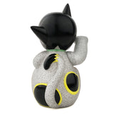 The Maneki-Astro — Silver Metallic Flake by DoomCo Designs, a Rotofugi Exclusive, is a small collectible cat figurine with glittery silver finish, black ears and tail, plus yellow-rimmed circles on its back and tail.