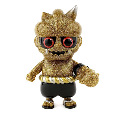 Oniki (The Ninja Tribe) — Oma by How2Work is a gold and black sofubi toy inspired by Japanese yokai, featuring red eyes, black shorts, a gold belt, a horned head, and claw-like hand.