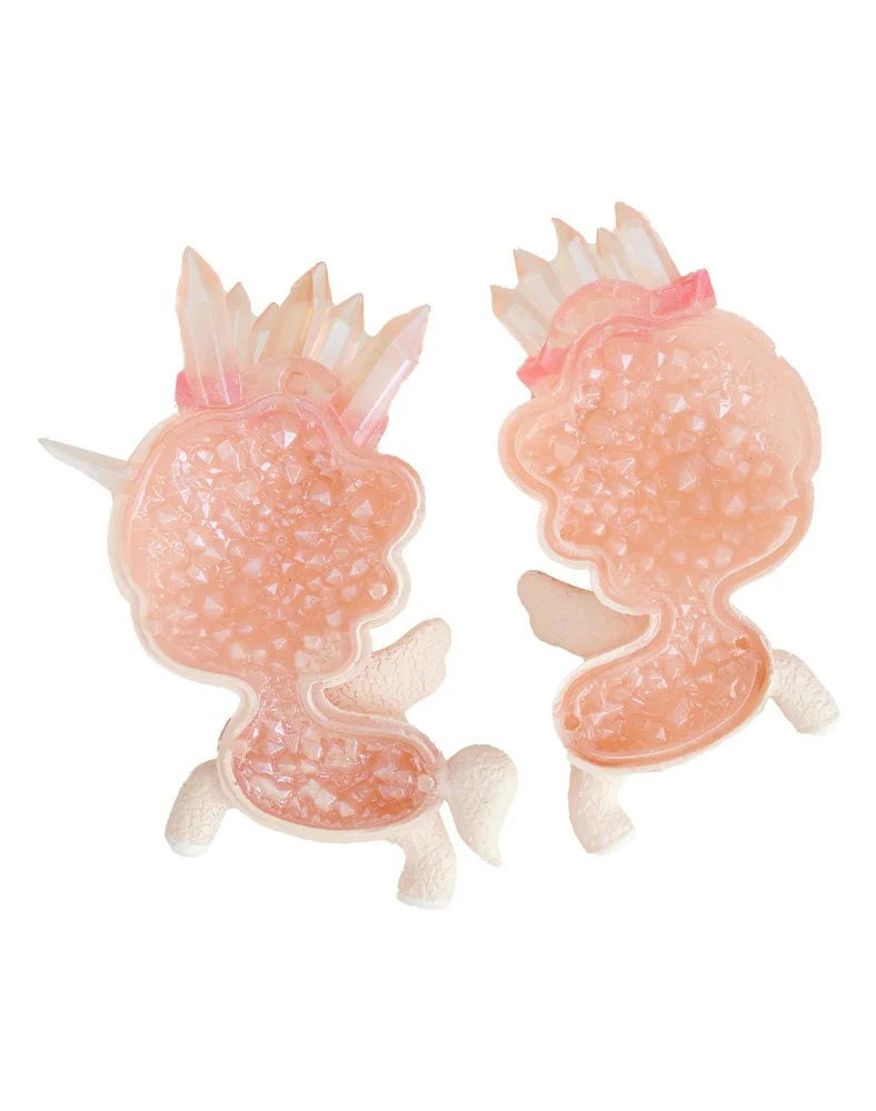 Two pink, unicorn-shaped resin brooches by tokidoki, called Tokidoki Precious Unicorno - Pink Aura Amethyst (Special Edition), feature textured surfaces, white accents, and spiky crowns inspired by amethyst healing properties, shown on a white background.