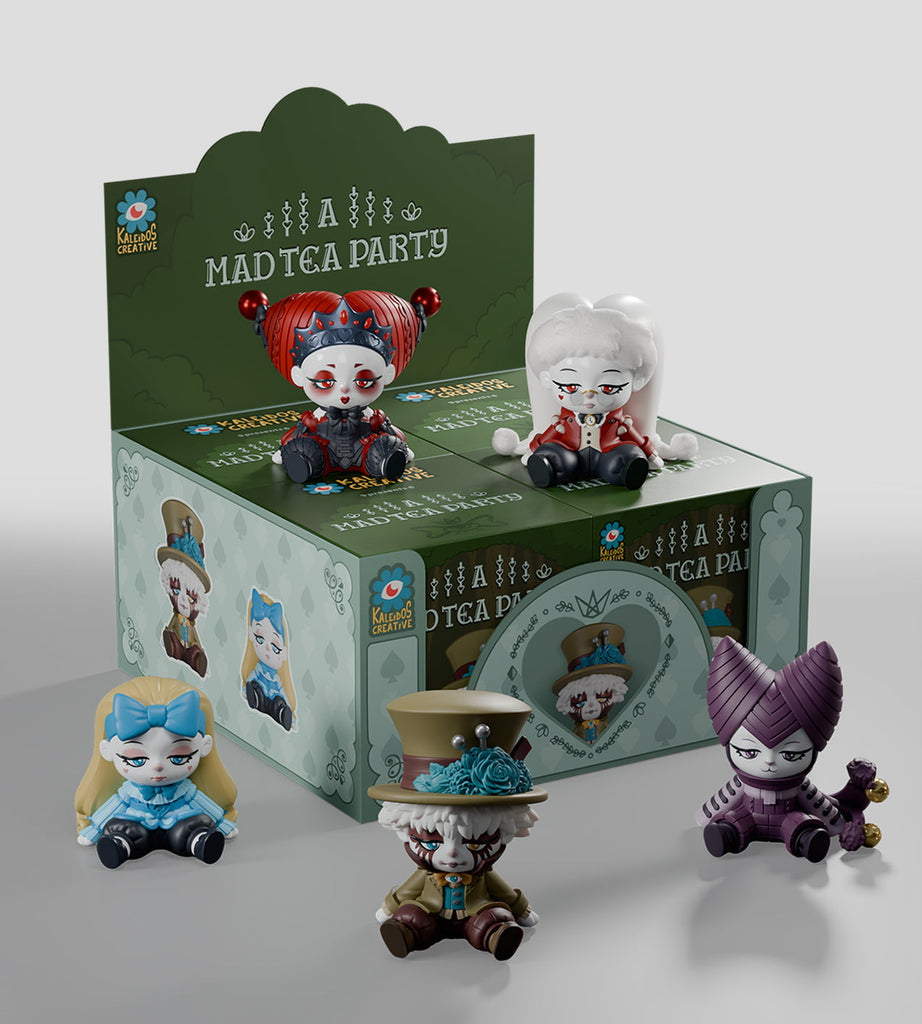 Four whimsical figurines are displayed before a green 