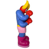 Side view of Lazy Boxer (OG) by The Little Hut—a colorful cartoon-style figure with red gloves, blue shirt, pink shorts, yellow horns, and pink boots—an eye-catching collectible set against a white background.