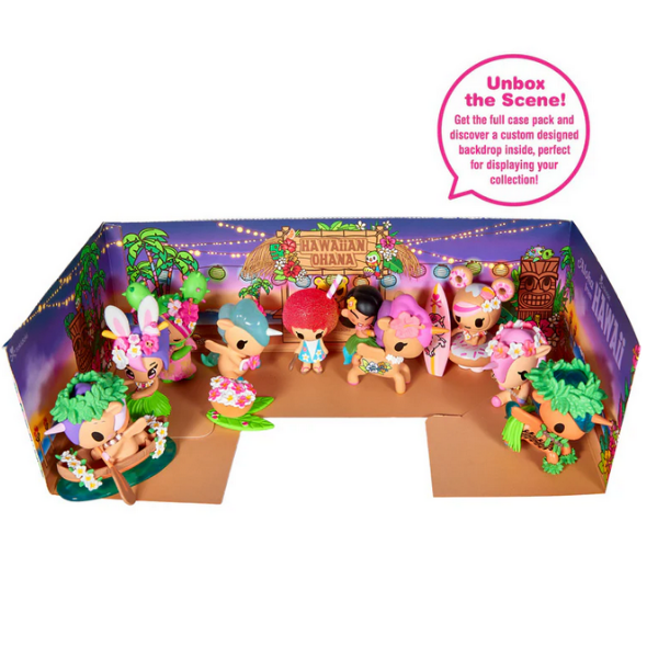Small, colorful figures from the tokidoki Hawaiian Ohana Blind Box by tokidoki are showcased in a “Hawaiian Ohana” cardboard scene with a tropical backdrop and playful accessories.