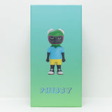 A box with a green-to-blue gradient background displays Phibby — OG (Green), a 12-inch limited edition vinyl collectible by Hebru Brand, showing the toy figure in a green helmet, blue shirt, yellow shorts, and sneakers.
