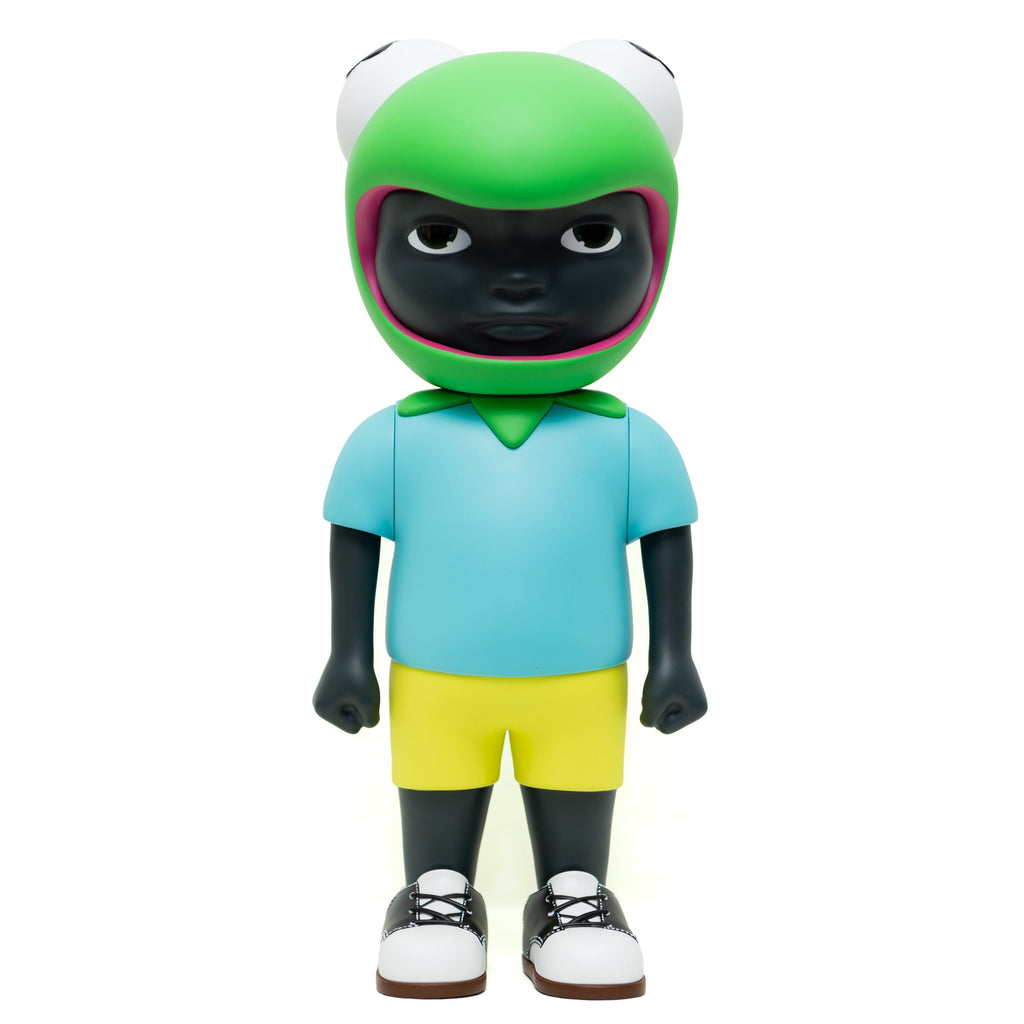 Phibby — OG (Green) by Hebru Brand is a limited edition collectible featuring a child with dark skin in a green frog helmet, blue shirt, yellow shorts, and white sneakers, standing forward.