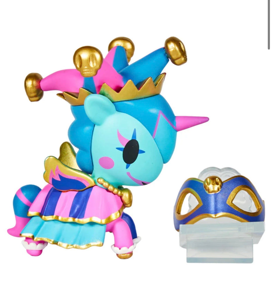 The tokidoki Unicorno After Dark Masquerade Blind Box features a blue and pink unicorn with a jester hat and gold accents, posed by a blue and gold mask on a clear stand—a must-have for any collectible toy fan.