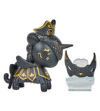 A black Unicorno After Dark Masquerade Blind Box figurine by tokidoki, adorned with gold accents, a decorated hat and skirt, stands beside a small black and silver ornate mask on a clear stand—a striking collectible for any display.