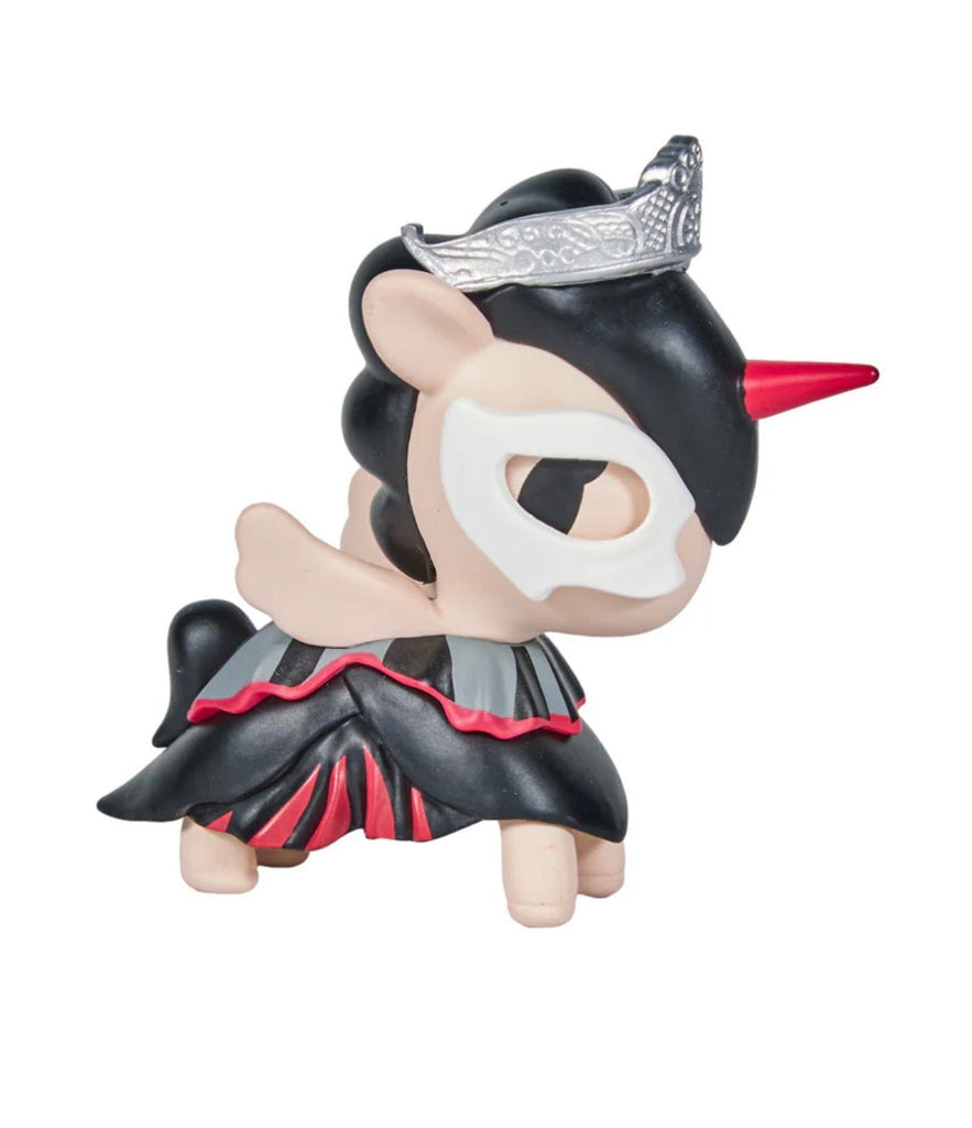 The tokidoki Unicorno After Dark Masquerade Blind Box features a collectible unicorn figurine in a black and red dress, with a silver tiara, black mask, and red horn, standing on all fours against a white background.