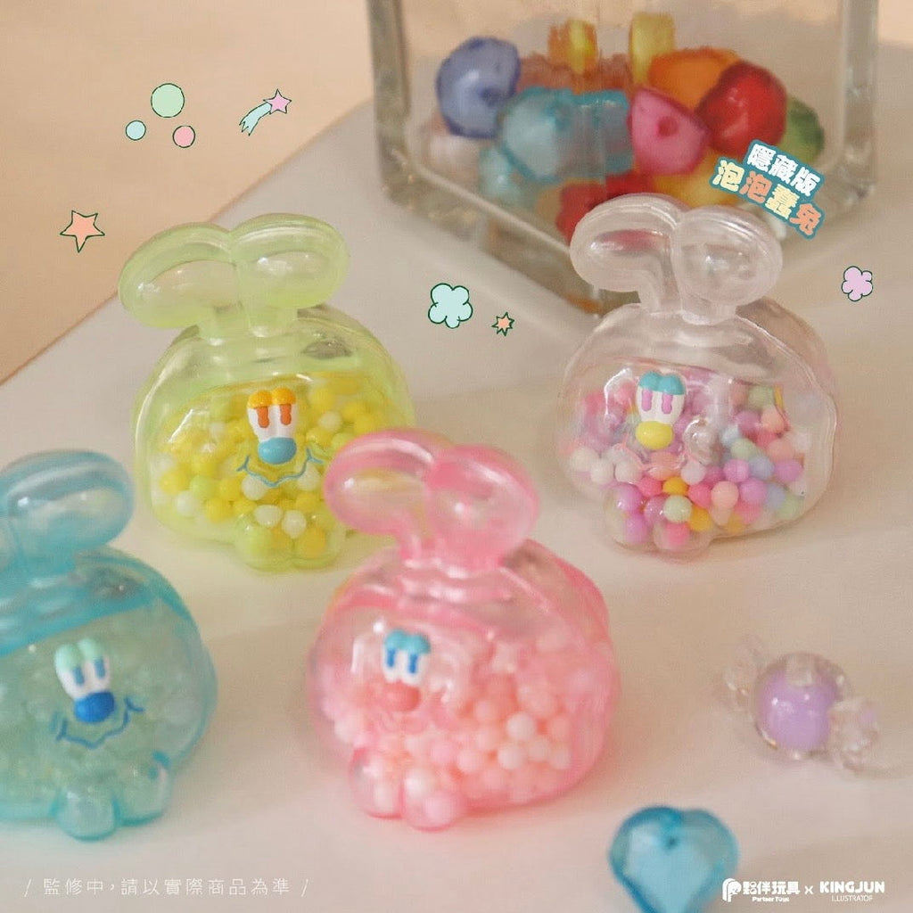 Four translucent bunny-shaped containers filled with colorful beads are displayed, resembling figures from the KINGJUN Candy Lab Blind Box series by Partner Toys, with a clear container and extra beads visible in the background.