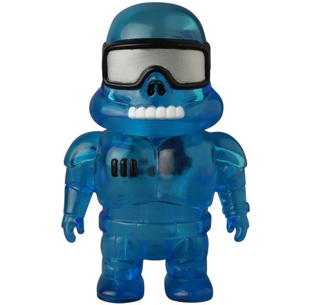 The VAG 45 — Space Controller by Medicom is a small blue transparent Japanese vinyl toy figure with a helmet, large goggles, a toothy grin, and a suit featuring three black marks on the chest.