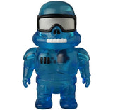 The VAG 45 — Space Controller by Medicom is a small blue transparent Japanese vinyl toy figure with a helmet, large goggles, a toothy grin, and a suit featuring three black marks on the chest.