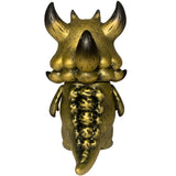 Rangeas Jr. - Gold Patina by The Little Hut: A golden, horned monster figure with textured skin, large tail, and small arms shown from the back against a white background. Collectible toy inspired by Rangeas Jr.