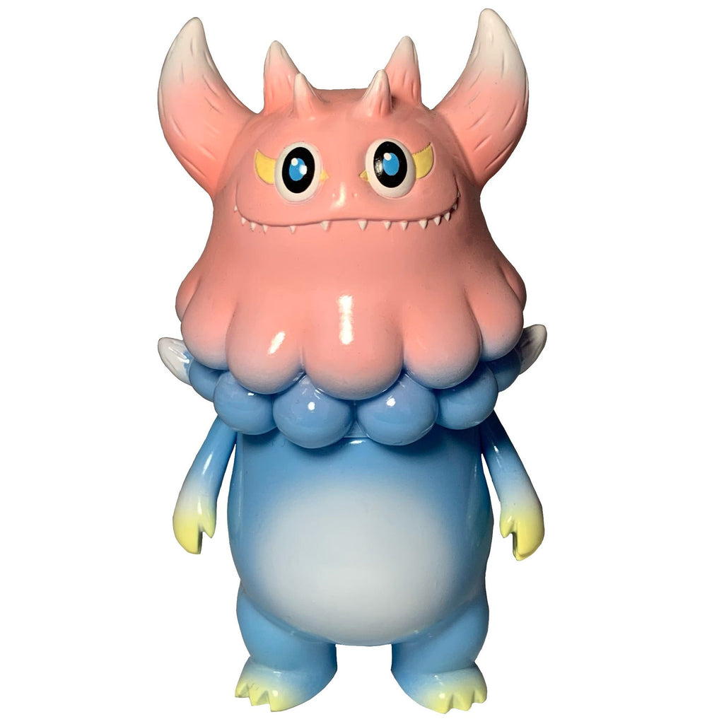 Rangeas Jr. - Light Blue/Pink by The Little Hut is a collectible monster figure with a pink horned head, blue and white body, clawed hands and feet, and large yellow eyes—displayed against a white background.