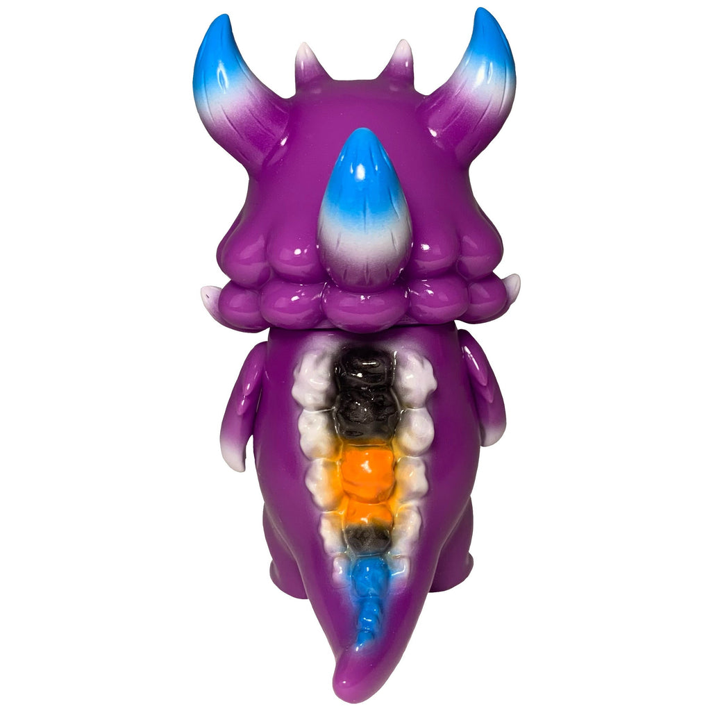 Rangeas Jr. - Purple by The Little Hut: a purple monster figurine with blue and white-tipped horns and colorful, exposed back segments—a striking collectible for fans.