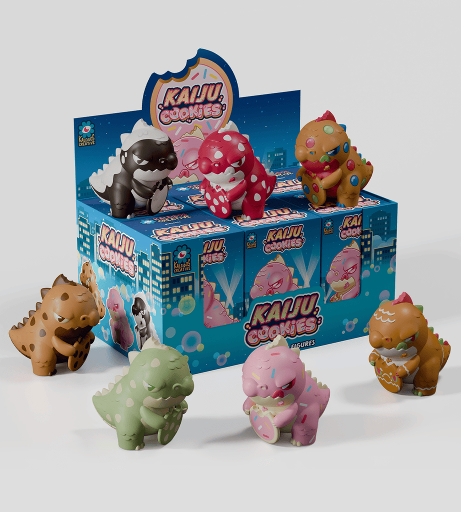 Six colorful Kaiju Cookie figurines—adorable, dinosaur-like creatures—are displayed before a blue Kaiju Cookies Blind Box from Kaleidos Creative, featuring matching graphics and branding.