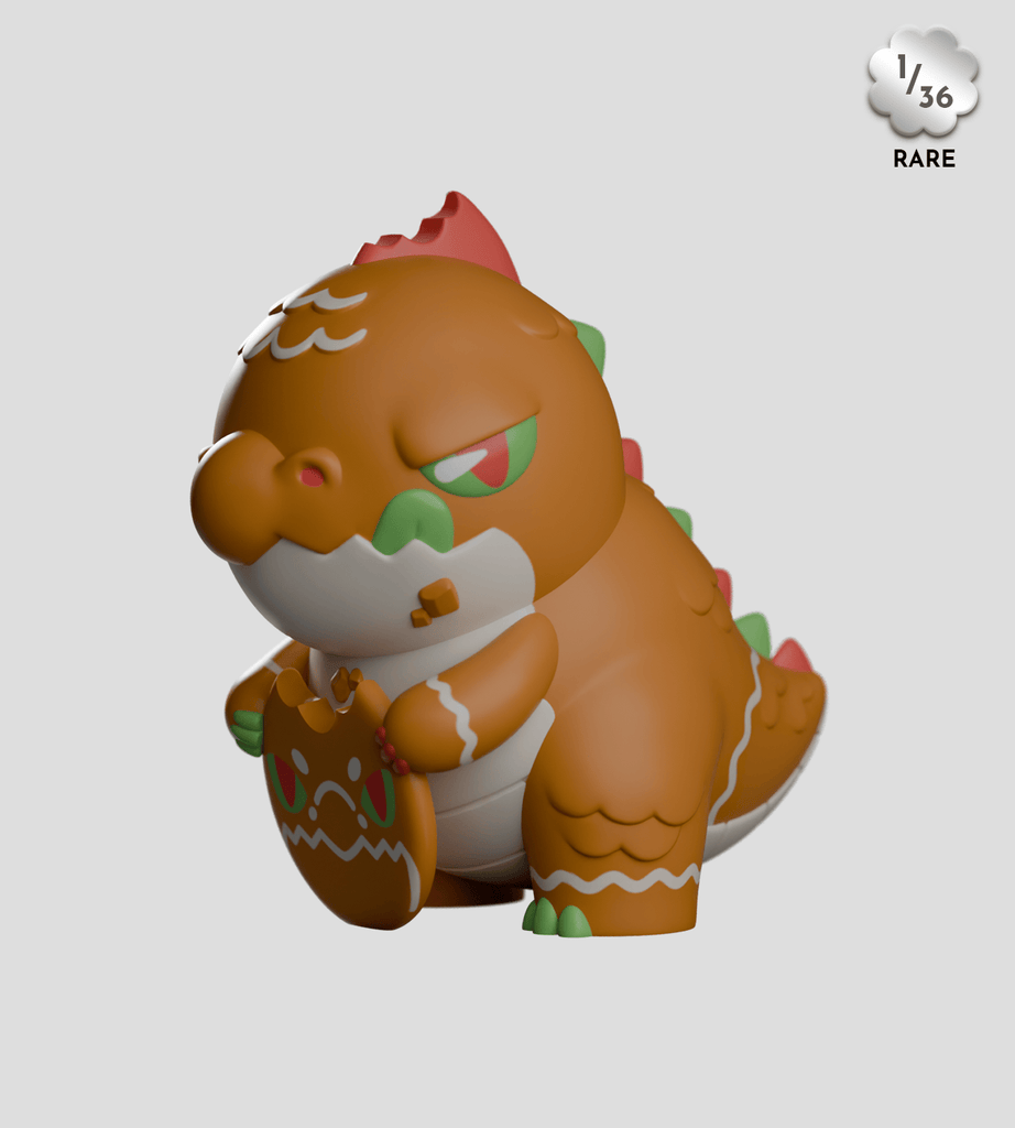 A rare 1-in-36 Kaleidos Creative Kaiju Cookies Blind Box toy dragon features green eyes, orange and white icing accents, and holds a bitten gingerbread cookie—perfect for cute creature fans and collectors.