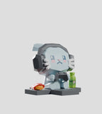 A Mega-Mini Arcade Blind Box figure by Kaleidos Creative—a polygonal cat with headphones—stands on a platform next to a wrapped sandwich and green bottle, set against a plain light gray background.