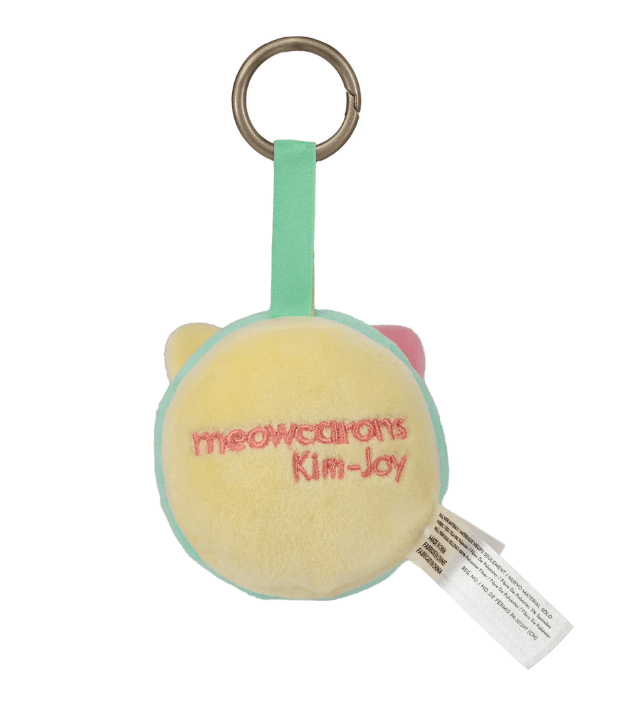 The Meowcaron Plush Bag Charm by Kaleidos Creative features cat ears, a pale yellow front, mint green trim, pink 
