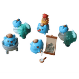 Five small blue Bugcat Capoo figurines interact with green objects like a painting scroll, cauldron, and sculptures—each inspired by the Partner Toys Bugcat Capoo — National Palace Museum Adventure Blind Box collection.