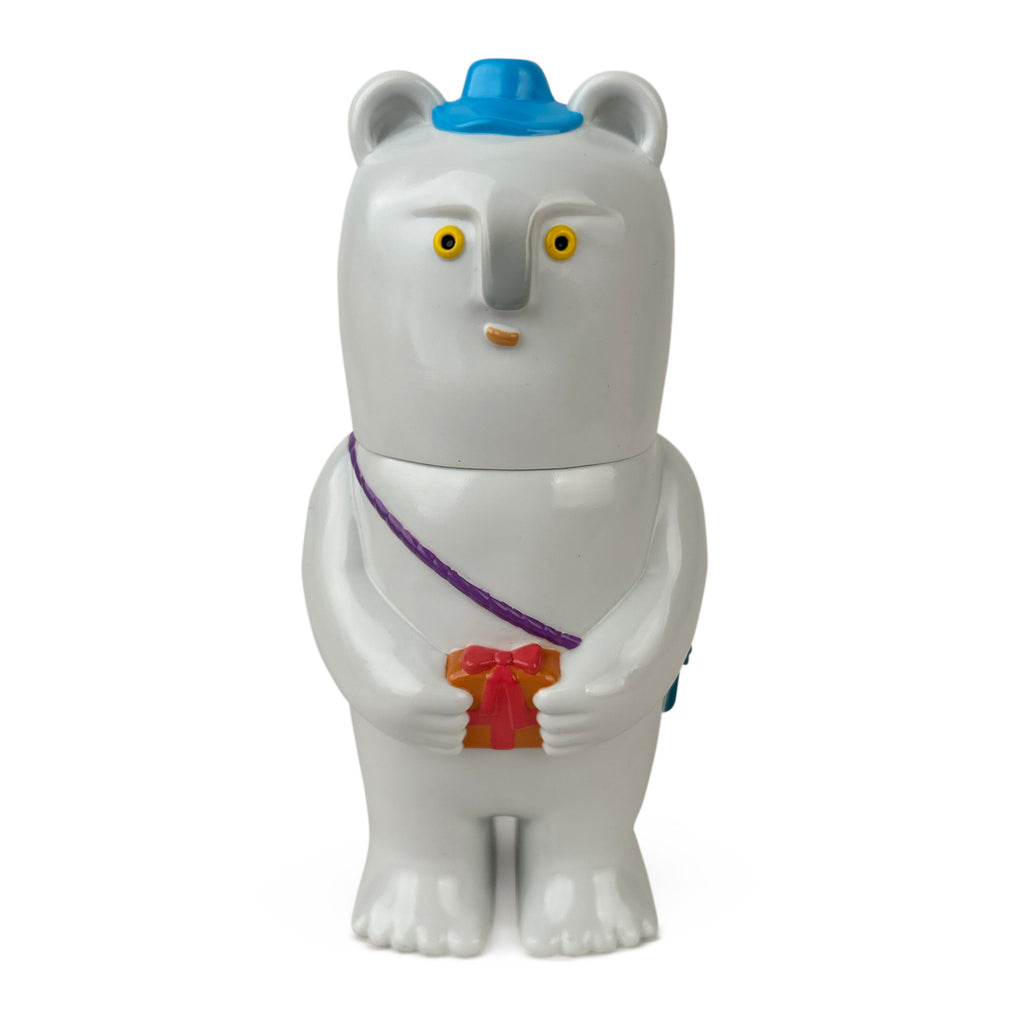 Kurichan — Number Three by Paradise Toy: a white bear-shaped figurine with a blue hat, yellow eyes, a purple strap, and holding a small red gift box.