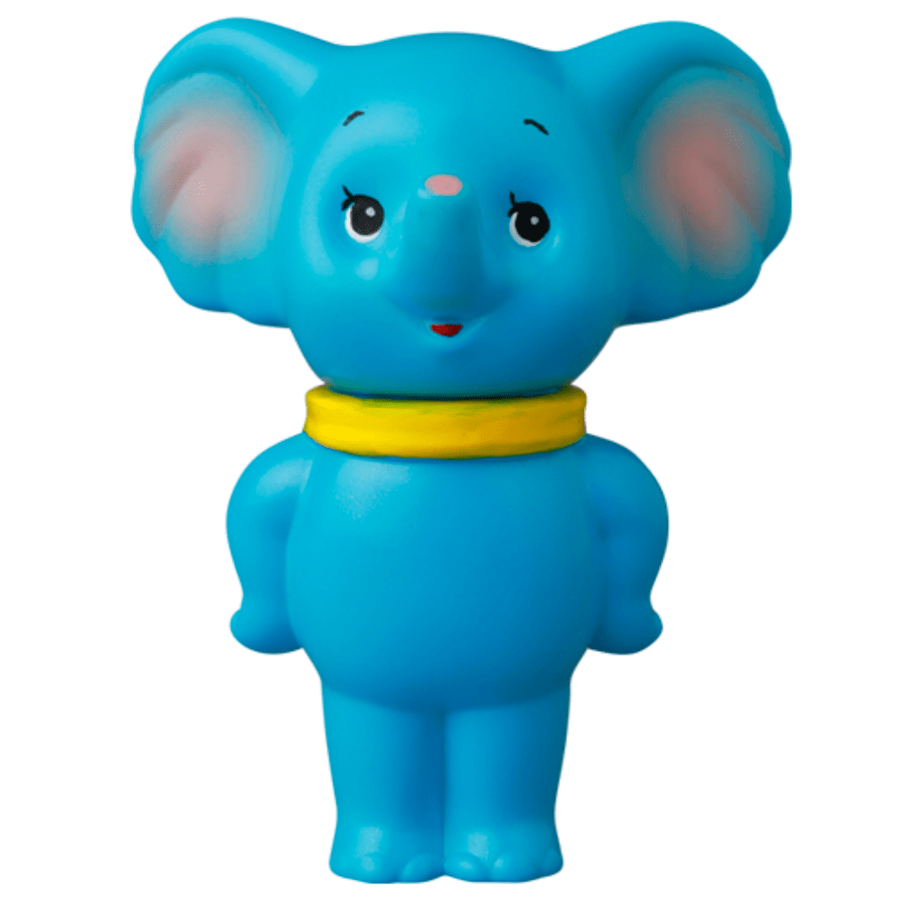 Medicom's VAG 43 — ZOU is a blue cartoon elephant figurine with a yellow collar, pink inner ears, and a smiling face, standing upright against white—its design draws inspiration from Japanese vinyl toys and gachapon figures.