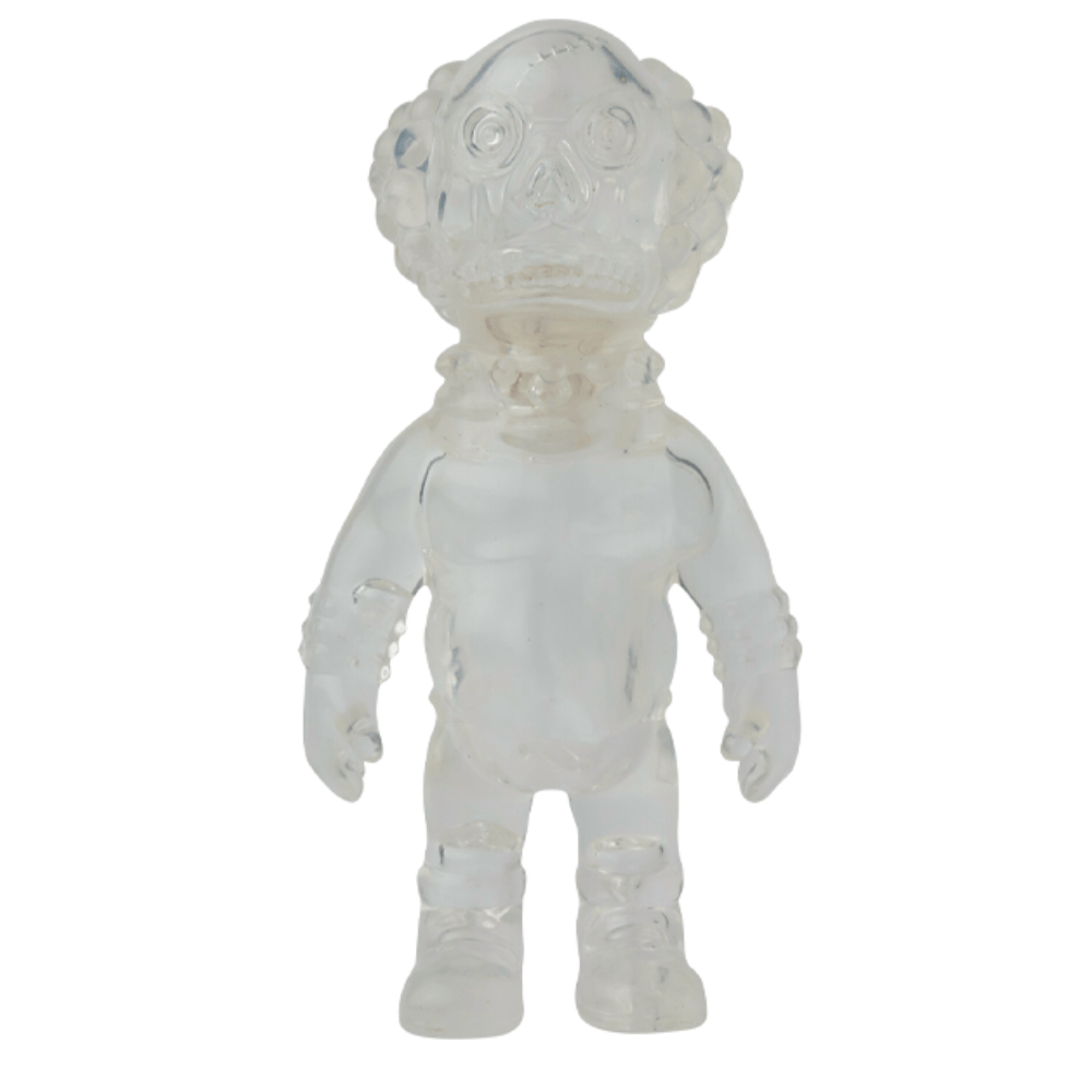 The VAG 36 - Deadman by Medicom is a clear plastic humanoid figure with a textured head, inspired by Japanese vinyl toy design, shown standing upright against a plain background.