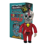 A skeleton figurine in a red suit and yellow tie stands before a colorful box labeled 