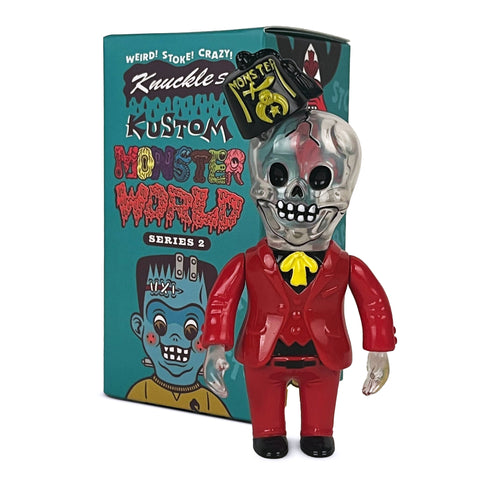 A skeleton figurine in a red suit and yellow tie stands before a colorful box labeled "Knuckle’s Kustom Monster World — Series 2 Blind Box" by How2Work, featuring collectible figures from the Kustom Monsters line.