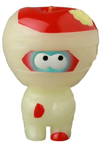The VAG 41 — Yummy Mummy by Medicom is a small Japanese vinyl toy featuring a large head, wide cartoon eyes, and off-white bandages with red and yellow accents.