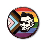 Show your support at any LGBTQ+ Center event with the Rotofugi Abe Progress Pride Hard Enamel Pin by Rotofugi—a round pin featuring a black and white portrait with an eye patch over a vibrant Progress Pride flag.
