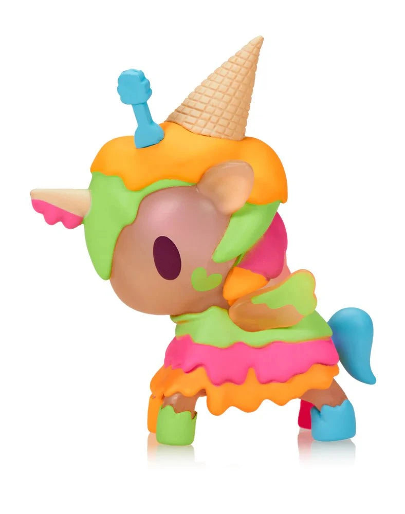 The tokidoki Ice Cream Shop Unicorno - Neon Melty (Special Edition) is a colorful unicorn figure with neon melty layers, a waffle cone on its head, and a blue bone, inspired by the Ice Cream Shop series. Shown against a white background.