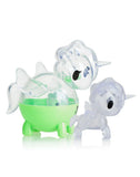 The tokidoki Unicorno Capsule Cuties Blind Box includes two translucent, cartoon-style unicorn figurines—one green and round with fins, the other smaller and clear—ideal for any Unicorno collector.