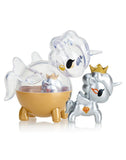 Two unicorn figurines from the tokidoki Unicorno Capsule Cuties Blind Box—a silver one with a gold crown and diamond motif, and a clear one with gold base and wings—make an ideal addition for Unicorno collectors.