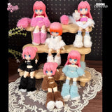 Six stylish Cat Island — Black Cat Or Candy Cat? Blind Box dolls by BIJIDI, each with pink hair and big blue eyes, wear colorful fluffy outfits and are displayed on a tiered wooden stand—cute surprises perfect for any blind box collection.
