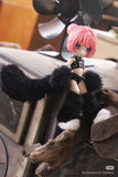 A small BIJIDI Cat Island — Black Cat Or Candy Cat? Blind Box doll with pink hair, blue eyes, and a black-and-white furry outfit sits on a branch indoors with a blurred fan in the background.