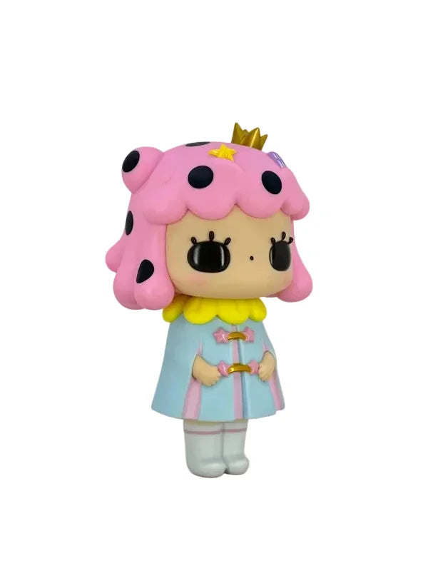 Cotton Candy by How2Work is a charming doll figure inspired by the character Jessica Ng, featuring pink hair with black dots, a small crown, pastel blue dress with yellow collar, white tights, and holding a wand—an adorable addition to any collection, photographed against a white background.