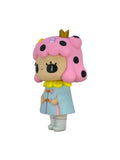 Cotton Candy by How2Work is an adorable character figurine featuring a girl with pink hair, black polka dots, a golden crown, blue coat, and white boots holding a flower—perfect for any collection—set against a white background.