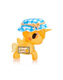A yellow squishy Toki Mochi Donut Unicorno Blind Bag figurine by tokidoki features a blue checkered hat and a 