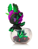 The tokidoki Neon Reef Mermicorno - Deep Star Coral Special Edition is a small black and purple unicorn figurine with green leaf details, perched on a clear plastic bowl of black and green elements and features glow-in-the-dark accents.