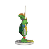 Side view of the Kidrobot Teenage Mutant Ninja Turtles TMNT GURU Resin Figure by CHOGRIN, holding a sword and standing on a round base—a must-have collectible for TMNT fans.