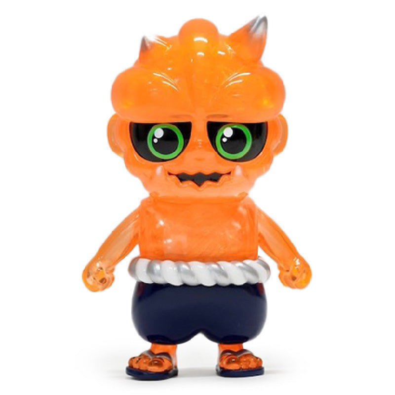 Oniki — Ghost by How2Work: an orange translucent toy figure with green eyes, fangs, small horns, dark pants, and a white rope belt, standing upright on a white background.