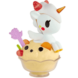 Discover the adorable Shaved Ice Dreams Unicorno Blind Box collectible toy by tokidoki! Featuring a Unicorno with strawberries on its head, sitting atop a bear-shaped scoop of ice cream in a glass dish, complete with a cherry and purple spoon—this delightful figure is perfect for any Blind Box fan!.