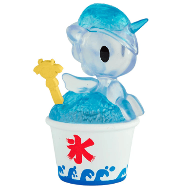 A translucent blue Shaved Ice Dreams Unicorno figurine from tokidoki’s Shaved Ice Dreams Unicorno Blind Box series sits atop blue shaved ice in a white cup with blue wave patterns and a red kanji symbol, holding a tiny yellow spoon—an irresistibly cute collectible.