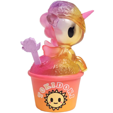 A vibrant Shaved Ice Dreams Unicorno Blind Box toy from tokidoki, featuring pink, yellow, and purple hues, sits in an orange cup adorned with a smiling sun logo and the “tokidoki” brand name. This adorable collectible includes a translucent purple spoon in the cup, making it a charming Blind Box surprise.