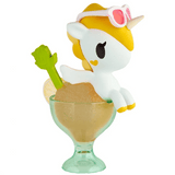 A charming tokidoki Shaved Ice Dreams Unicorno Blind Box collectible, featuring sunglasses, sits perched on the rim of a green glass dessert cup filled with a scoop of ice cream and a decorative green spoon—making it the perfect addition to your Blind Box collection.