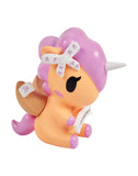 The tokidoki Fortune Cookie Unicorno Blind Box features a small figurine with a light orange body, purple mane and tail, white horn, and skull bow details—perfect as a surprise addition to any collection.